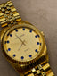 Distinctive Luxury Men's Gold Watch with Blue Stone Pips