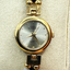 Gloria Vanderbilt Gold Watch with White Abalone and Black Stripe Band – Effortless Elegance